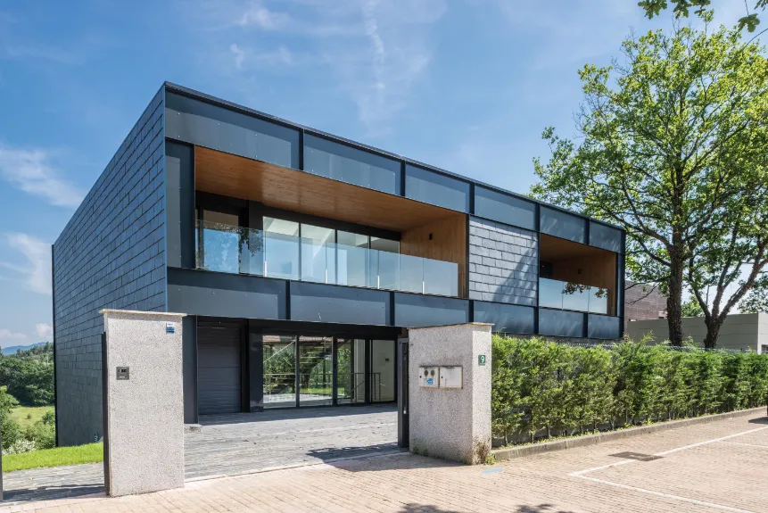 Fachada frontal de vivienda moderna con sistema Thermochip Housing y cerramiento industrializado